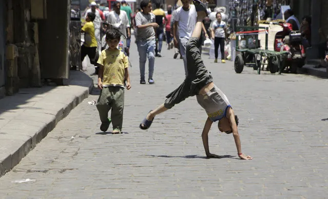 Egyptian boys play at El-Moez Street in historical Fatimid Cairo, Egypt, Tuesday, July 28, 2015. (Photo by Amr Nabil/AP Photo)