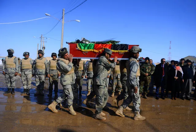 Afghan border police personnel carry a coffin of a victim killed on the Ukrainian Airlines flight PS752 crashed in Iran, at Islam Qala on the outskirts of Herat near the border between Afghanistan and Iran on January 17, 2020. (Photo by Hoshang Hashimi/AFP Photo)