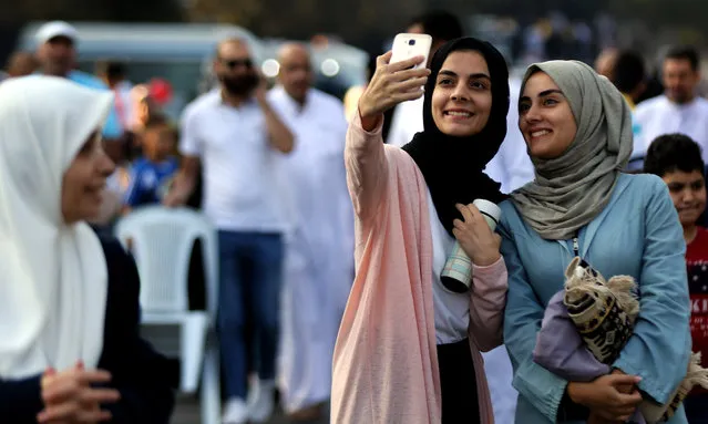 Jordanians pose for photos during the Eid al-Adha festival in Amman, Jordan, September 1, 2017. (Photo by Mohammad Abu Ghosh/Xinhua/Barcroft Images)