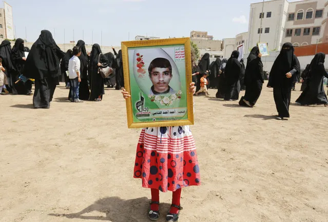 A Yemeni girl holds a picture of her brother allegedly killed in Yemen's ongoing conflict, during a rally against Saudi-led airstrikes, in Sana'a, Yemen, 23 August 2017. According to reports, at least 54 people were killed and dozens of others wounded in the Yemeni capital on 23 August 2017 when the Saudi-led international coalition carried out airstrikes on Houthi rebels in Sana'a. (Photo by Yahya Arhab/EPA/EFE)