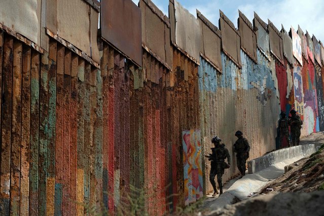 Mexico's Navy officers patrol in Playas de Tijuana near the US/Mexico border, Baja California State, Mexico, on September 28, 2023. In the last 11 months, at least 1.8 million people have reached the southern US border, many of them searching for safety and economic opportunities. (Photo by Guillermo Arias/AFP Photo)