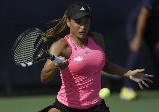 Monica Puig, of Puerto Rico, returns a shot against Andrea Petkovic, of Germany, during the second round of the 2014 U.S. Open tennis tournament, Wednesday, August 27, 2014, in New York. (Photo by Frank Franklin II/AP Photo)