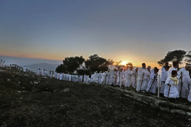 Samaritans walk up to pray on Mount Gerizim, near the northern West Bank city of Nablus, during celebrations for the holiday of Sukkot (the Tabernacles Feast), which marks the exodus of the ancient Hebrew people from Egypt, on October 4, 2017. (Photo by Jaafar Ashtiyeh/AFP Photo)