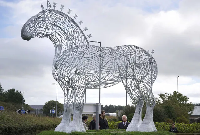 Britain's Prince Charles, known as the Duke of Rothesay and Patron of the Clydesdale Horse Society, views a statue of a Clydesdale horse situated by Lanark Auction Market, Lanark Agricultural Centre, in Lanarkshire, Scotland, Wednesday, September 7, 2022. (Photo by Andrew Milligan/PA Wire via AP Photo)