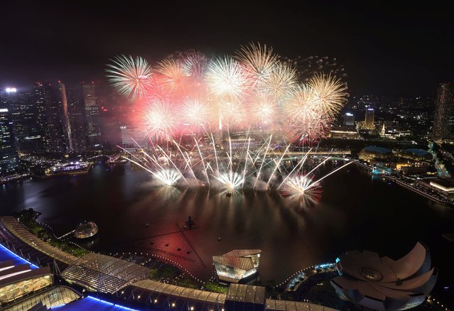 Fireworks explode over the Marina Bay during the New Year celebrations in Singapore on December 31, 2023. (Photo by Edgar Su/Reuters)