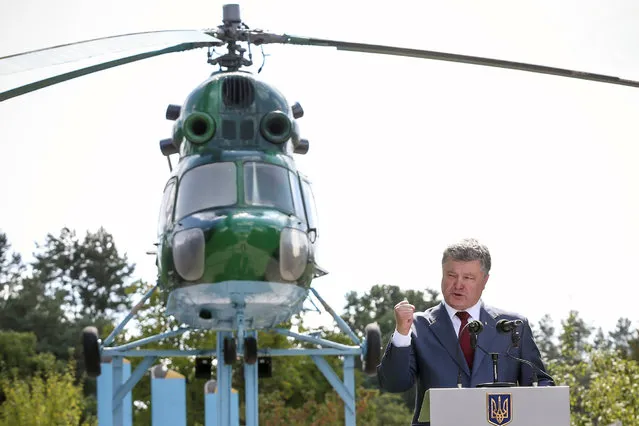 Ukrainian President Petro Poroshenko addresses servicemen of the 16th separate army aviation brigade and relatilves of pilots, who were killed in the fighting in eastern Ukraine, in the city of Brody, Ukraine, August 18, 2016. (Photo by Mykhailo Markiv/Reuters/Ukrainian Presidential Press Service)