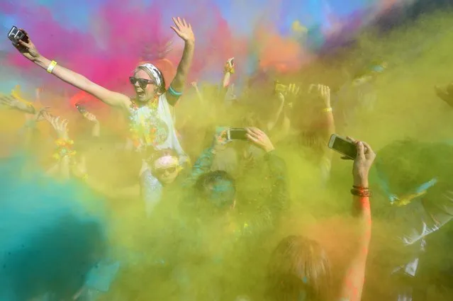 A runner participates in the annual Color Run in Centennial Park in Sydney on August 21, 2016.  
The Color Run is a 5km fun run started in the US in 2012 and is inspired by the traditional Hindu festival Holi, where people throw natural coloured powders as the seasons change from winter to spring. (Photo by Peter Parks/AFP Photo)