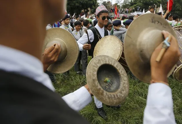 People dressed in traditional attire play musical instruments as they take part in a celebration a day after the first democratic constitution was announced in Kathmandu, Nepal September 21, 2015. (Photo by Navesh Chitrakar/Reuters)