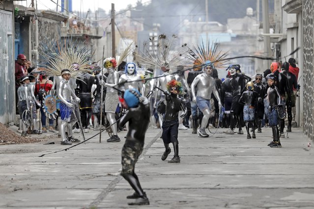 People participate in the Xinacates Carnival, in San Nicolas de los Ranchos, in Puebla, Mexico, 25 March 2025. Every year, locals and visitors paint their bodies in silver or black and dance in the streets of the town to celebrate carnival ahead of the holy week. (Photo by Hilda Rios/EPA/EFE)