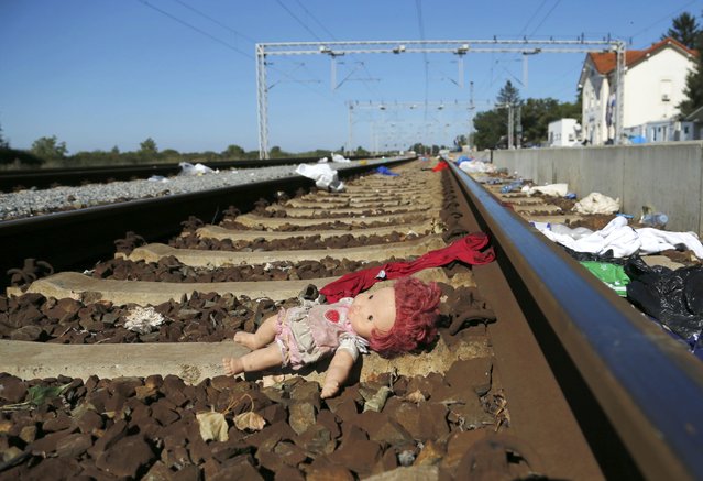 An abandoned doll lies on a rail track strewn with rubbish at the train station in Tovarnik, Croatia September 21, 2015. Croatia will demand that Greece stop moving migrants from the Middle East on to the rest of Europe, Interior Minister Ranko Ostojic said on Monday. (Photo by Antonio Bronic/Reuters)