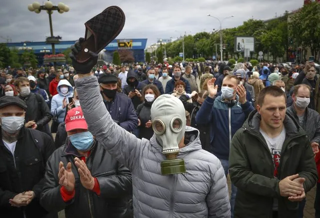 A man, wearing a mask to protect against coronavirus, attends a rally to support for potential presidential candidates in the upcoming presidential elections in Minsk, Belarus, Sunday, May 31, 2020. A human rights group in Belarus says more than 30 people have been detained amid demonstrations against authoritarian President Alexander Lukashenko running for another term. The presidential campaign is underway in Belarus despite the coronavirus outbreak after the parliament and government refused to postpone the election scheduled for August 9. (Photo by Sergei Grits/AP Photo)