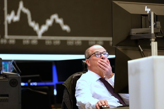 A trader sits on the trading floor of the Frankfurt Stock Exchange in front of the display board showing the DAX stock index in Frankfurt, Germany, Wednesday, April 9, 2025. (Photo by Martin Meissner/AP Photo)