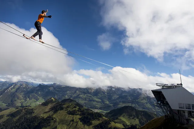 Guillaume Roland, a professional mountaineer, balances on the “highline” during the European Highline Meeting on the top of the Moleson mountain at 2,000 meters above the sea level, in the Swiss Alps, near Fribourg, Switzerland, October 17, 2014. (Photo by Jean-Christophe Bott/EPA)