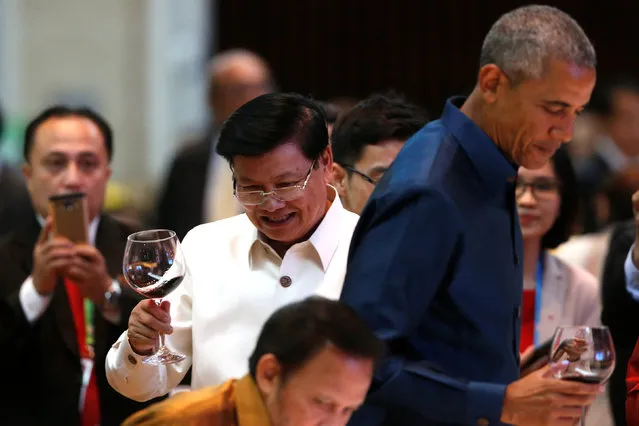 Laos Prime Minister Thongloun Sisoulith shares a toast with U.S. President Barack Obama and other world leaders at the start of the ASEAN Summit gala dinner in Vientiane, Laos September 7, 2016. (Photo by Jonathan Ernst/Reuters)