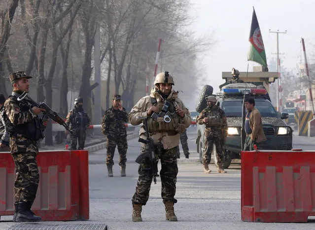 Afghan security forces keep watch at a check point close to a compound of Afghanistan's national intelligence agency in Kabul, Afghanistan. December 25, 2017. (Photo by Omar Sobhani/Reuters)