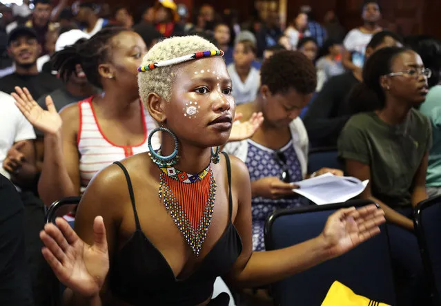 A student from the University of Cape Town claps her hands as she and other students chant and sing as they gather to discuss possible student fee increases at there campus in Cape Town, South Africa, Monday, September 19, 2016. South Africa's government says universities in the country can increase fees by no more than 8 percent next year, despite student warnings that they would protest against any new hikes. (Photo by Schalk van Zuydam/AP Photo)