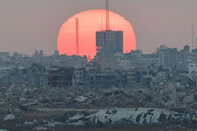 The sun sets over Gaza, as seen from Israel, on July 1, 2025. (Photo by Amir Cohen/Reuters)