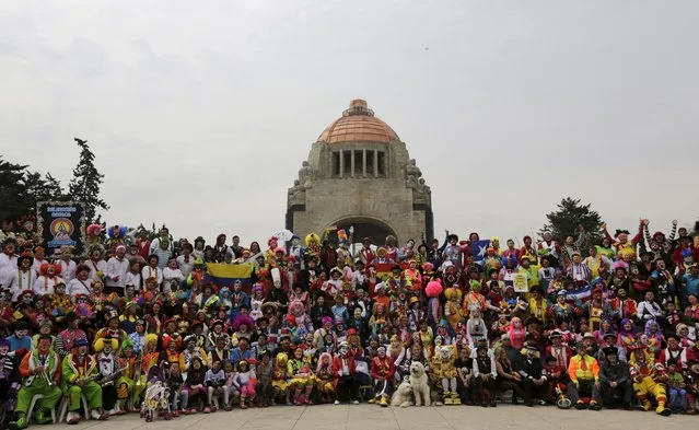 Clowns pose for a photo in front of the Monument to the Revolution during the Latin American Clown Convention in Mexico City, Mexico, October 21, 2015. (Photo by Henry Romero/Reuters)