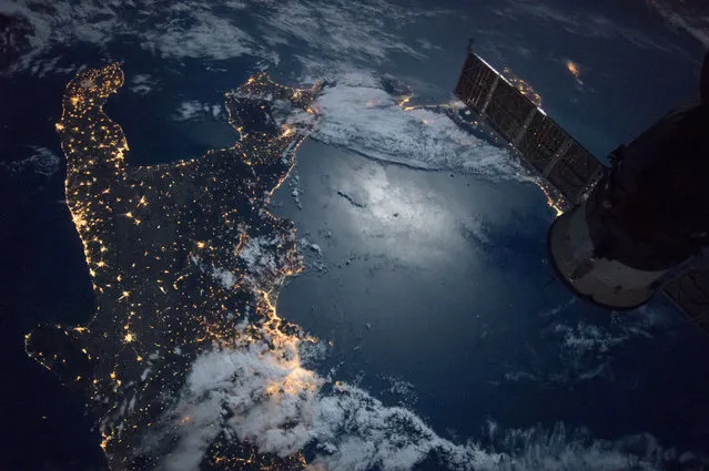 The southern tip of Italy is visible in this image taken by the Expedition 49 crew aboard the International Space Station on September 17, 2016. The brightly lit city of Naples can be seen in the bottom section of the image. A Russian Soyuz spacecraft docked at the station is at right. (Photo by NASA)