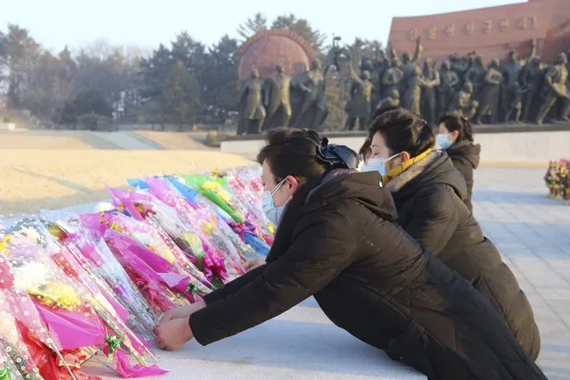 Pyongyang citizens visit Mansu Hill to pay respect to the statues of their late leaders Kim Il Sung and Kim Jong Il on the occasion of the 75th founding anniversary of the Korean People's Army in Pyongyang, North Korea Wednesday, February 8, 2023. (Photo by Cha Song Ho/AP Photo)