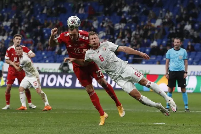 Russia's Artem Dzyuba, left, and Hungary's Willi Orban jump for the ball during the UEFA Nations League soccer match between Russia and Hungary at Dinamo Stadium in Moscow, Russia, Wednesday, October 14, 2020. (Photo by Pavel Golovkin/AP Photo/Pool)