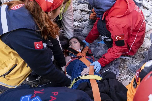 Rescue workers and medics pull out a person from a collapsed building in Antakya, Turkey, Wednesday, February 15, 2023. More than 35,000 people have died in Turkey as a result of last week's earthquake, making it the deadliest such disaster since the country's founding 100 years ago. (Photo by Ugur Yildirim/DIA via AP Photo)