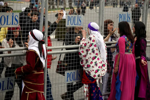 Participants stand behind security barriers during a rally on the International Women's Day in Diyarbakir, Turkey on March 8, 2018. (Photo by Sertac Kayar/Reuters)