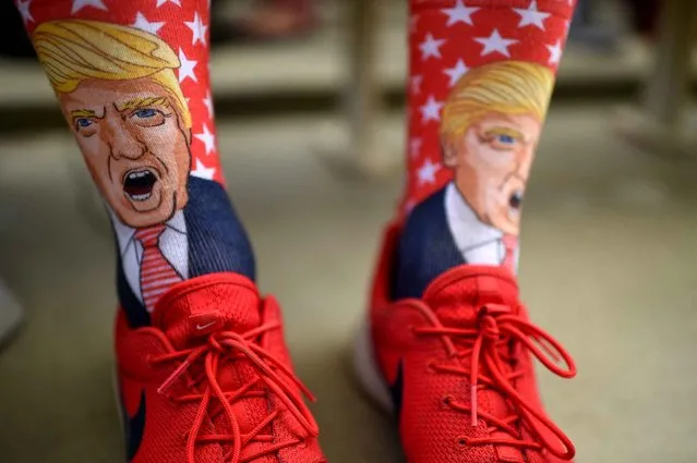 Terrence O'Hagan from Mission Viejo, California wears socks decorated with an image of Republican presidential candidate Donald Trump during a campagin rally for Trump on October, 5, 2016 at the Henderson Pavilion in Henderson, Nevada. (Photo by Robyn Beck/AFP Photo)