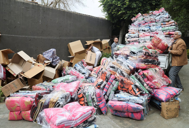 Men prepare blankets and clothes to be donated to Turkey, following the devastating earthquake, before dispatch in Cairo, Egypt on February 12, 2023. (Photo by Amr Abdallah Dalsh/Reuters)
