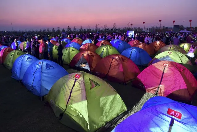 People stand next to tents during a tent cultural festival in Hefei, Anhui province, China, October 17, 2015. Nearly 500 tents and about 1,000 people participated in the festival, local media reported. (Photo by Reuters/Stringer)