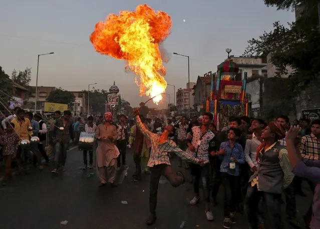 A man performs with fire during a Muharram procession to mark Ashura in Ahmedabad, India, October 24, 2015. Ashura, which falls on the 10th day of the Islamic month of Muharram, commemorates the death of Imam Hussein, grandson of Prophet Mohammad, who was killed in the seventh century battle of Kerbala. (Photo by Amit Dave/Reuters)
