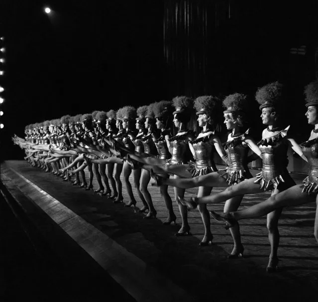 The 36 Rockettes go through a dance number as they rehearse for their Christmas show at Radio City Music Hall in New York in December 1963. (Photo by Dan Grossi/AP Photo)