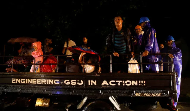 Residents who evacuated their homes due to Typhoon Haima ride on a government truck as they are transported to an evacuation centre  in San Fernando, la Union in northern Philippines, October 19, 2016. (Photo by Erik De Castro/Reuters)