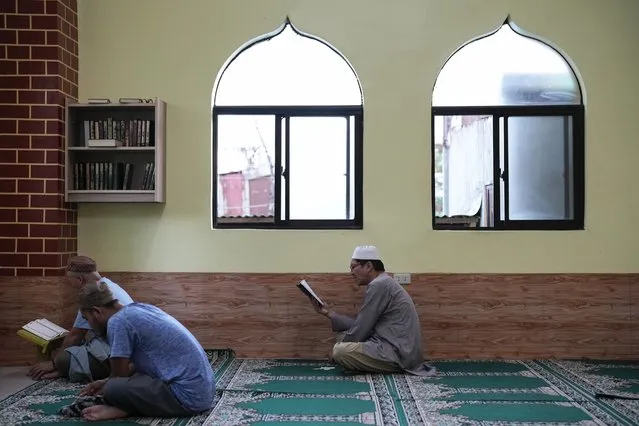 A Filipino Muslims read the Quran inside a mosque on the first day of the Muslim holy fasting month of Ramadan in Marikina, Philippines on Thursday, March 23, 2023. (Photo by Aaron Favila/AP Photo)