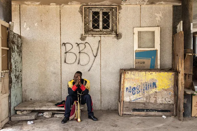 A member of the National Brass Band pauses during celebrations for Senegal’s 63rd Independence Day in Dakar on April 04, 2023. (Photo by John Wessels/AFP Photo)