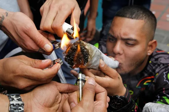A man smokes marijuana during a Global March for Marijuana in Medellin, Colombia, May 5, 2018. The annual Global Marijuana March is taking place in over 100 cities across the world in an effort to raise awareness of the benefits of medical cannabis and to call for the legalization of marijuana. (Photo by Fredy Builes/Reuters)