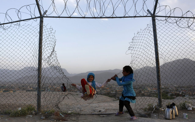 Afghan girls play in Kabul, May 20, 2013. (Photo by Mohammad Ismail/Reuters)