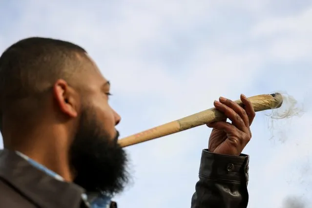A man smokes a giant joint during the informal annual cannabis holiday, 4/20 (four-twenty), corresponding to the numerical figure widely recognized within the cannabis subculture as a symbol for all things related to marijuana, in Denver, Colorado, U.S., April 20, 2023. (Photo by Kevin Mohatt/Reuters)