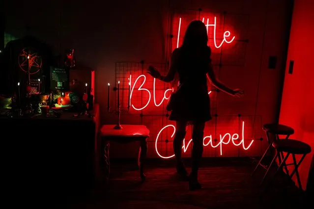 An attendee poses for a photograph inside the Little Black Chapel at the Satanic Temple's Satancon 2023, which they call an “in-person conference for congregations, campaigns, members, and supporters”, in Boston, Massachusetts, U.S., April 28, 2023. (Photo by Brian Snyder/Reuters)