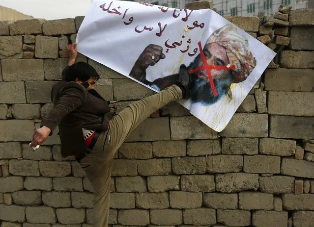 An Afghan man kicks a poster of Pakistani religious leader Maulana Fazlur Rehman during a demonstration against his visit in Kabul, January 8, 2015. (Photo by Omar Sobhani/Reuters)