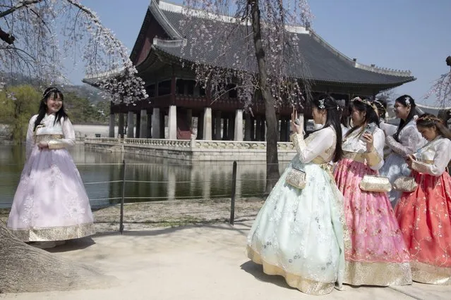 Tourists wearing Hanbok, a Korean traditional dress, take pictures during a visit at the Gyeongbokgung Palace in Seoul, South Korea, 30 March 2023. Gyeongbokgung, the main palace of the Joseon dynasty, has been used as a setting for numerous films and TV dramas and it has become a mecca for Korean Wave tourism. (Photo by Jeon Heon-Kyun/EPA/EFE/Rex Features/Shutterstock)