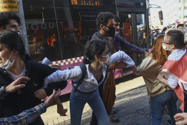 Protesters hold each other during scuffles with Turkish police officers at a demonstration in Istanbul, Tuesday, June 2, 2020, against the recent killing of George Floyd by police officers in Minneapolis, USA, that has led to protests in many countries and across the US. (Photo by Omer Kuscu/AP Photo)