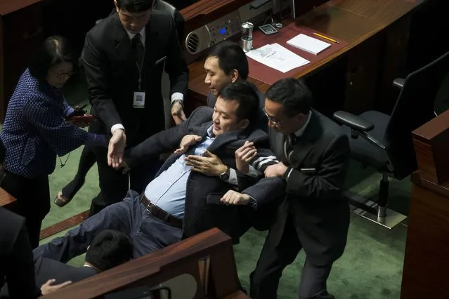 People Power party lawmaker Raymond Chan is carried off by security guards after shouting at Hong Kong's Chief Executive Leung Chun-Ying (not pictured) during Leung's annual policy address at the Legislative Council in Hong Kong January 14, 2015. (Photo by Tyrone Siu/Reuters)