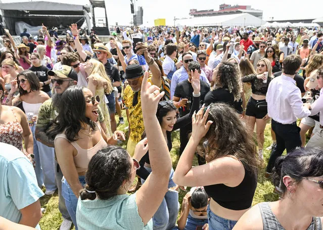 Race fans dance in the infield as DJ Chantel Jeffries performs during the 148th running of the Preakness Stakes at Pimlico Race Course on May 20, 2023. (Photo by Jonathan Newton/The Washington Post)