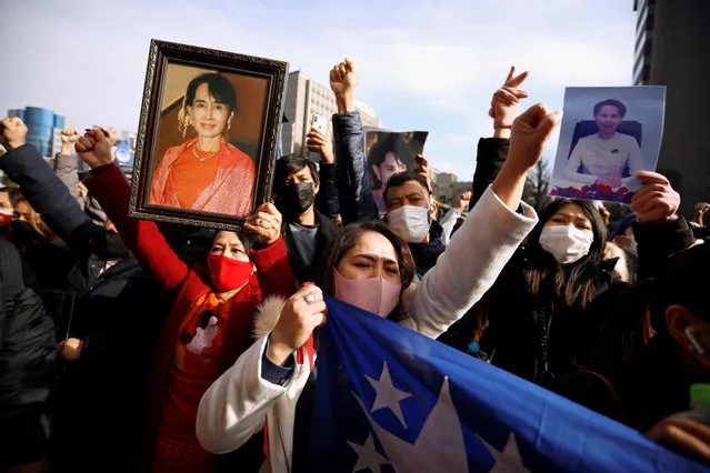 Myanmar protesters residing in Japan hold photos of Aung San Suu Kyi as they rally against Myanmar's military after seizing power from a democratically elected civilian government and arresting its leader Aung San Suu Kyi, at United Nations University in Tokyo, Japan on February 1, 2021. (Photo by Issei Kato/Reuters)