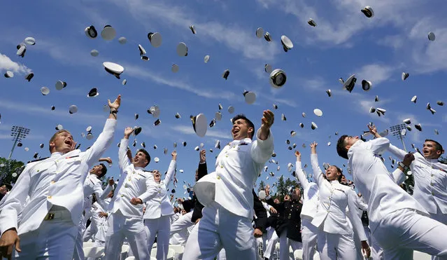 Graduates toss their caps in the air in celebration at the conclusion of the U.S. Naval Academy graduation and commissioning ceremony in Annapolis, Maryland, U.S., May 26, 2023. (Photo by Kevin Lamarque/Reuters)