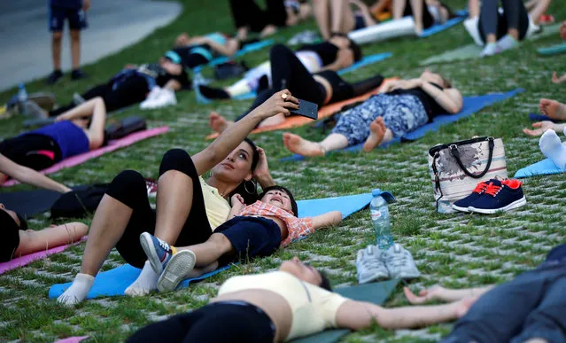 A woman takes a selfie during a yoga class on International Yoga Day in Tbilisi, Georgia on June 21, 2018. (Photo by David Mdzinarishvili/Reuters)