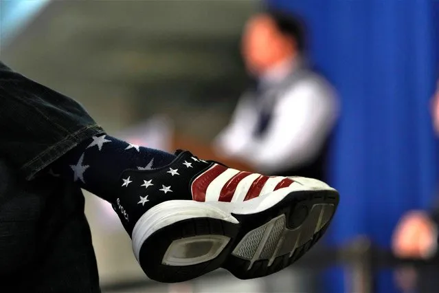 An audience member wearing a flag themed shoe as he listens to Republican presidential candidate Florida Gov. Ron DeSantis speak during a campaign event, Wednesday, May 31, 2023, in Cedar Rapids, Iowa. (Photo by Charlie Neibergall/AP Photo)