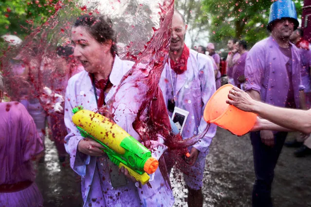 A reveller has wine thrown at her during the Batalla de Vino (Wine Battle) in Haro, Spain, June 29, 2018. (Photo by Vincent West/Reuters)