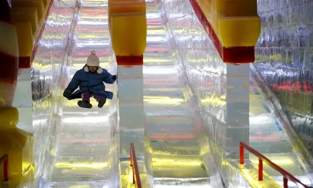 A young girl makes her way down a slide made entirely of ice, part of the ICE! event at Maryland's National Harbor just outside of Washington December 15, 2015. (Photo by Kevin Lamarque/Reuters)